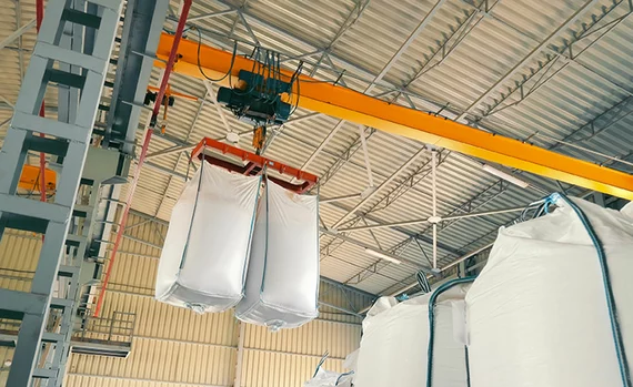 Industrial Crane Lifting Bulk Bags in Warehouse